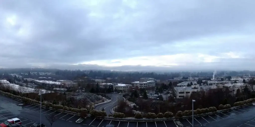 panoramic winter view of bothell, washington with snow-dusted buildings, roads, and evergreen trees